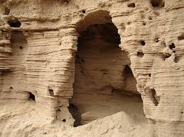 A  cave   in a sand wall 