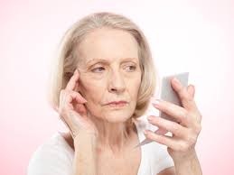 aging woman looking in the - via Daymix
