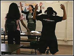Students perform jumping jacks - via Daymix