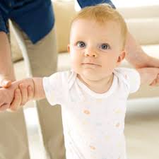 TEACHING A CHILD TO WALK.