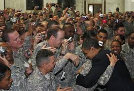 Barack Obama is greeted by
