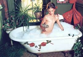 posed naked in a bathtub.