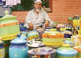 A craftsman displays his Khurja ...