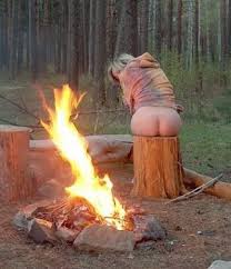 woman warms her bare bottom by a