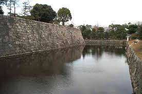The huge  moat   and immense walls    