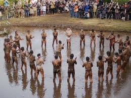 Half  naked men   gathered in cold    