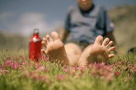Woman bare feet in flower field
