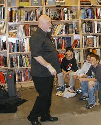 Brian Jacques engages with his fans -- his wife keeps them moving ...