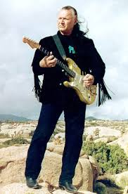Dick Dale strums his guitar outdoors